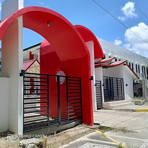 The red arched gate of the TUP Cavite campus in Salawag, Dasmariñas